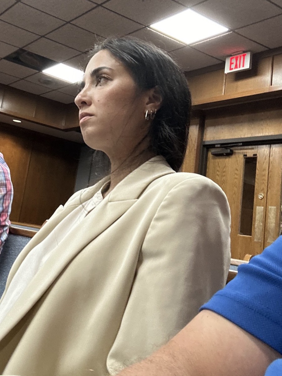 Roo Powell seated in a courtroom